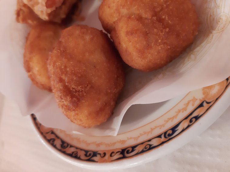 Spanish croquetas on a plate with a doily