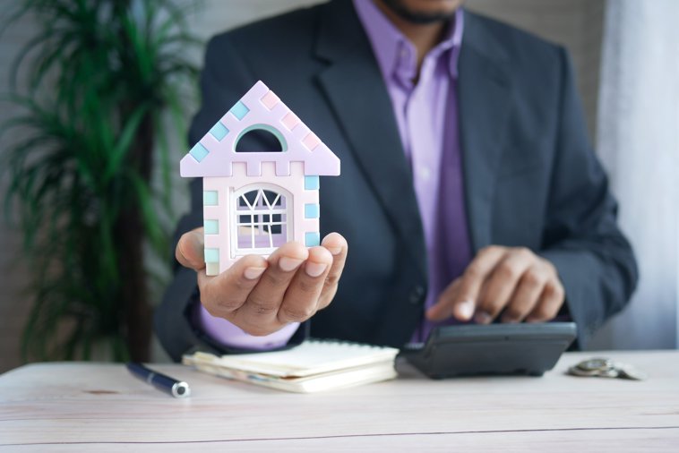 banker with house in hand