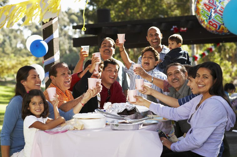 latino family toasting at a barbecue