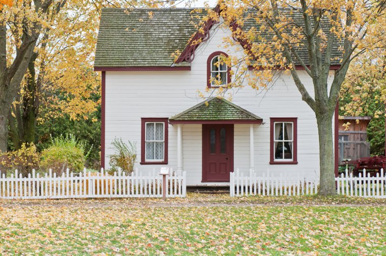 fall secene small house with white picket fence