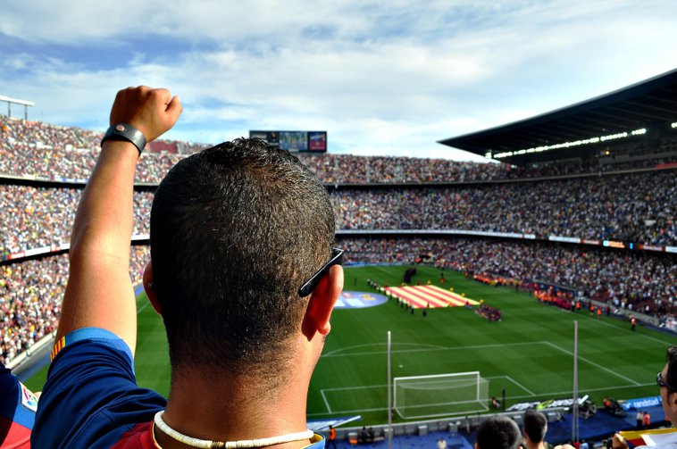 latino soccer fan cheering on his soccer club