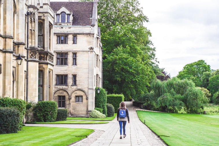 student walking across Oxford campus