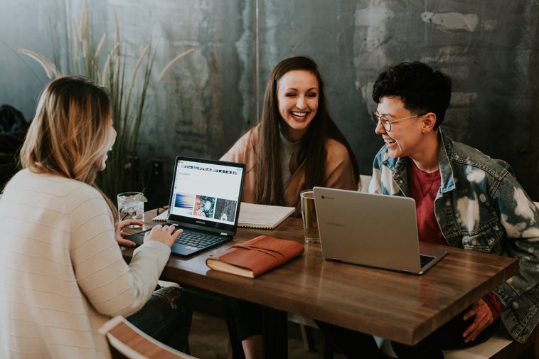three people studying and talking